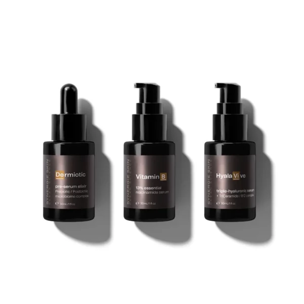 Three dark-colored bottles with pumps are lined up against a white background. The labels read Dermotic, Vitamin B, and Hyala Vive. Each product is part of the Great Barrier Treat collection, offering skincare benefits perfect for travel enthusiasts exploring destinations like the Great Barrier Reef.